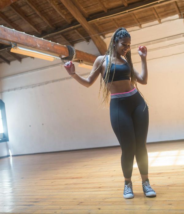 Woman feeling energetic and vibrant in a bright space.